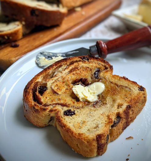 Slice of cinnamon raisin bread with vegan butter